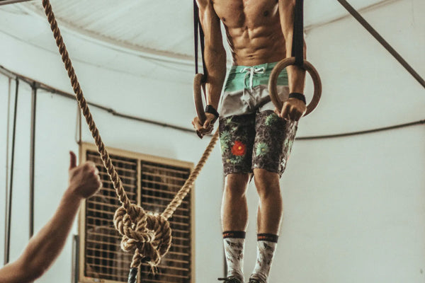 Athlete performing a muscle-up on gymnastic rings during training