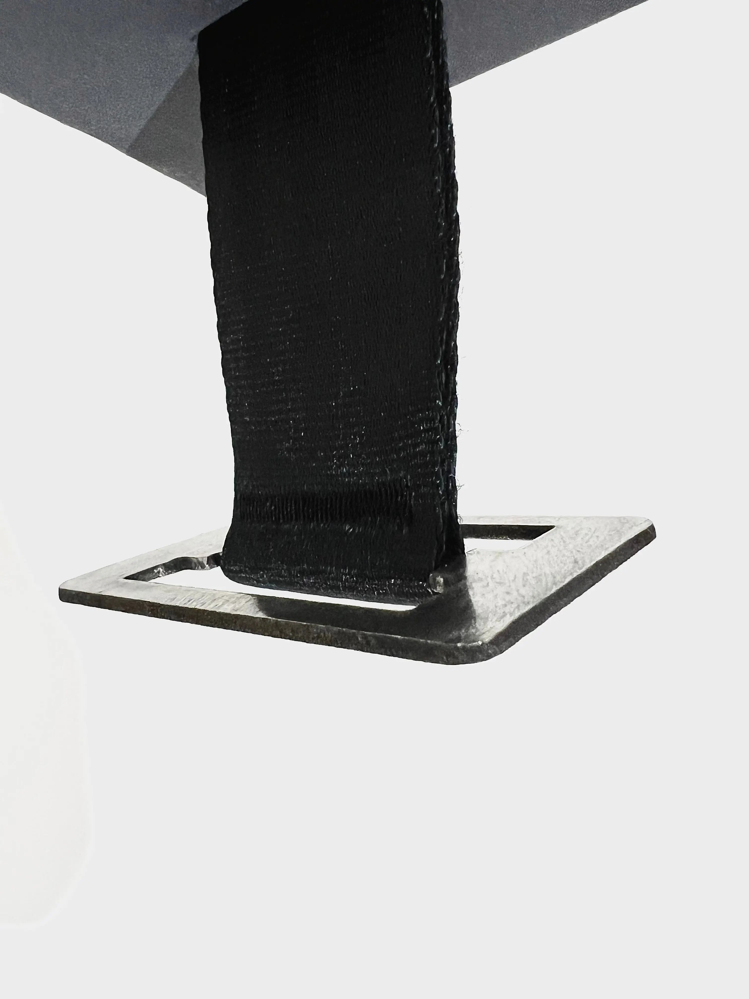 Close-up of a black metal bracket on a white background