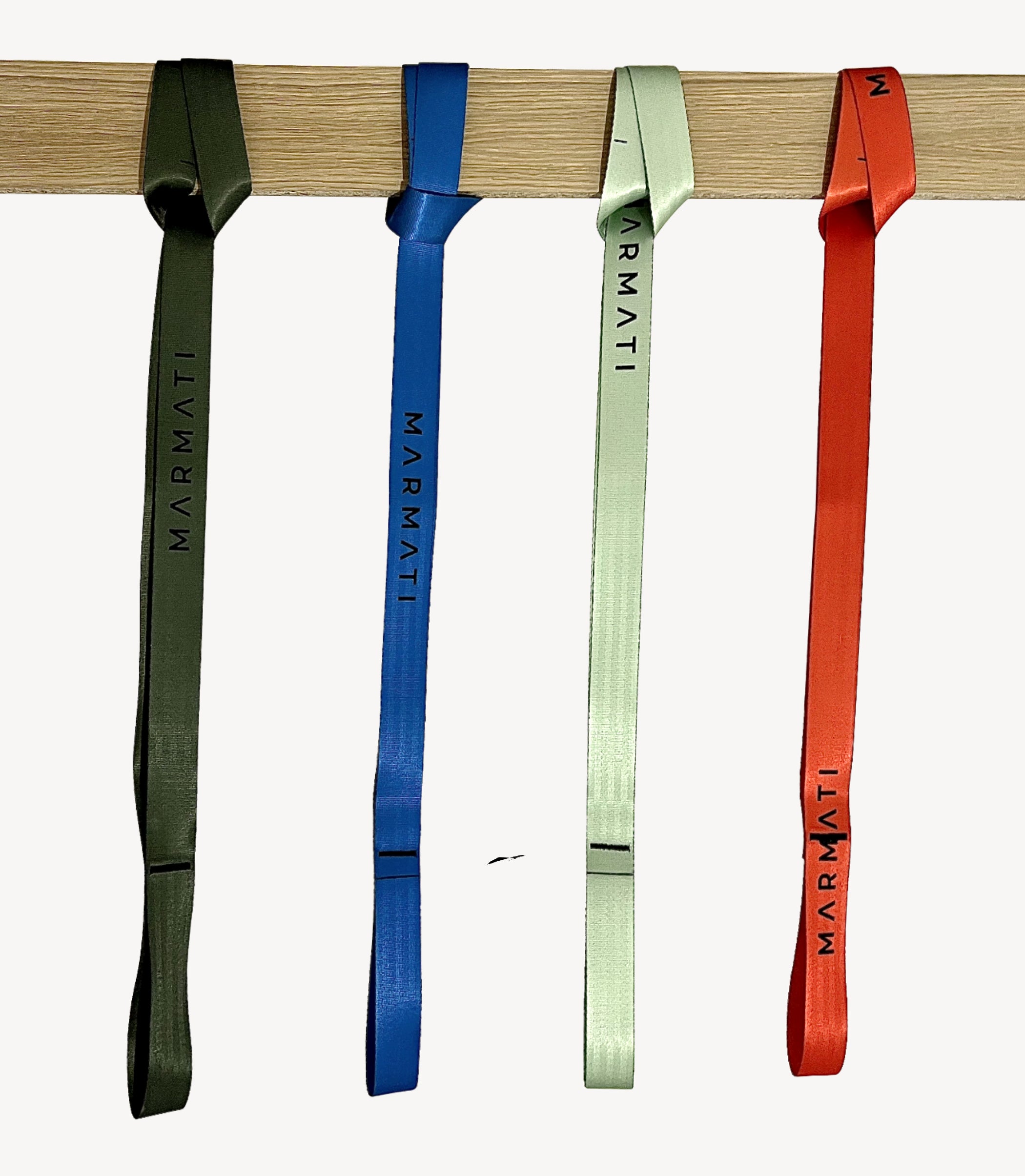 Four colorful straps with 'Marmati' branding hanging on a wooden bar.