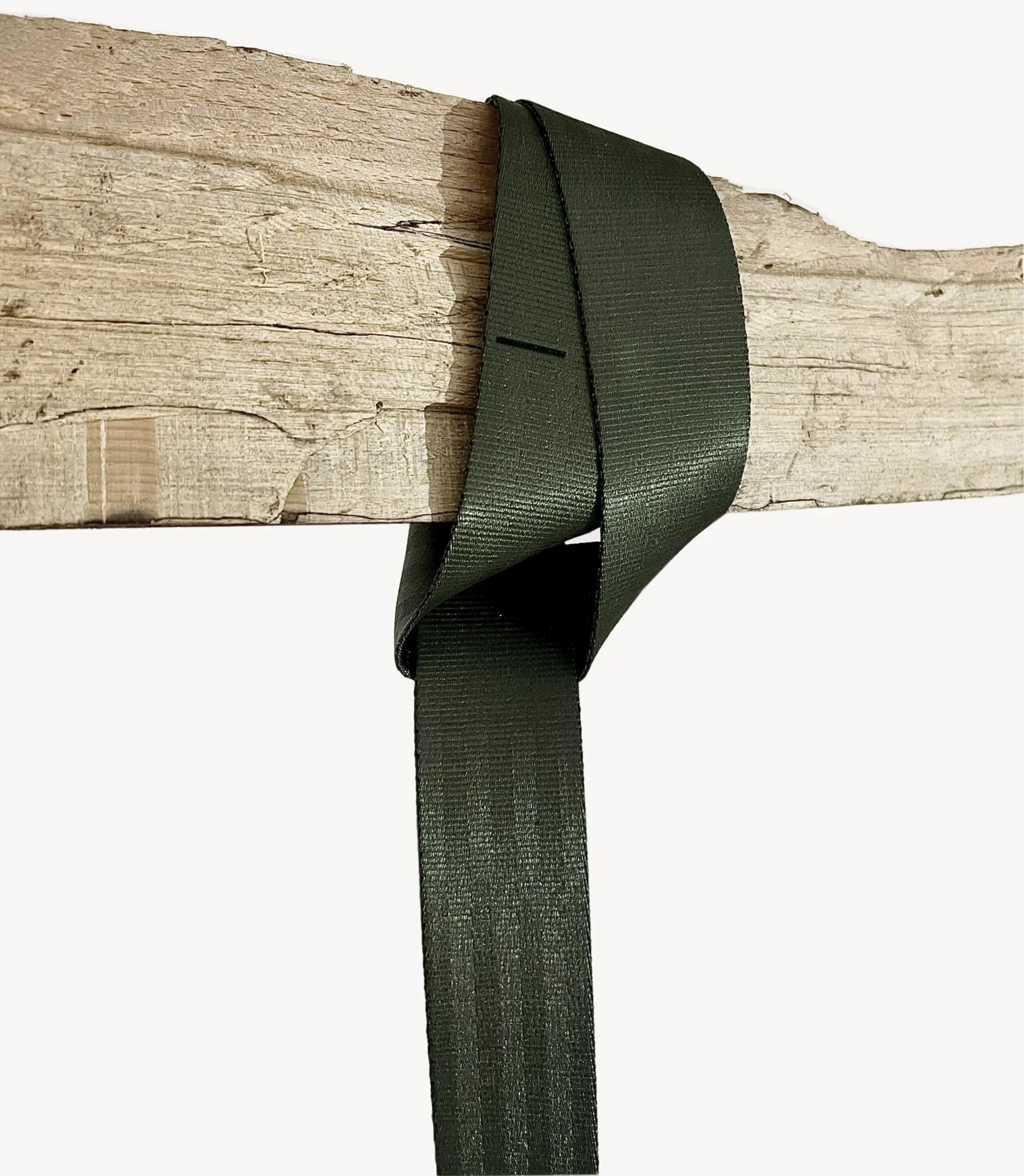Green ribbon tied in a bow on a wooden surface