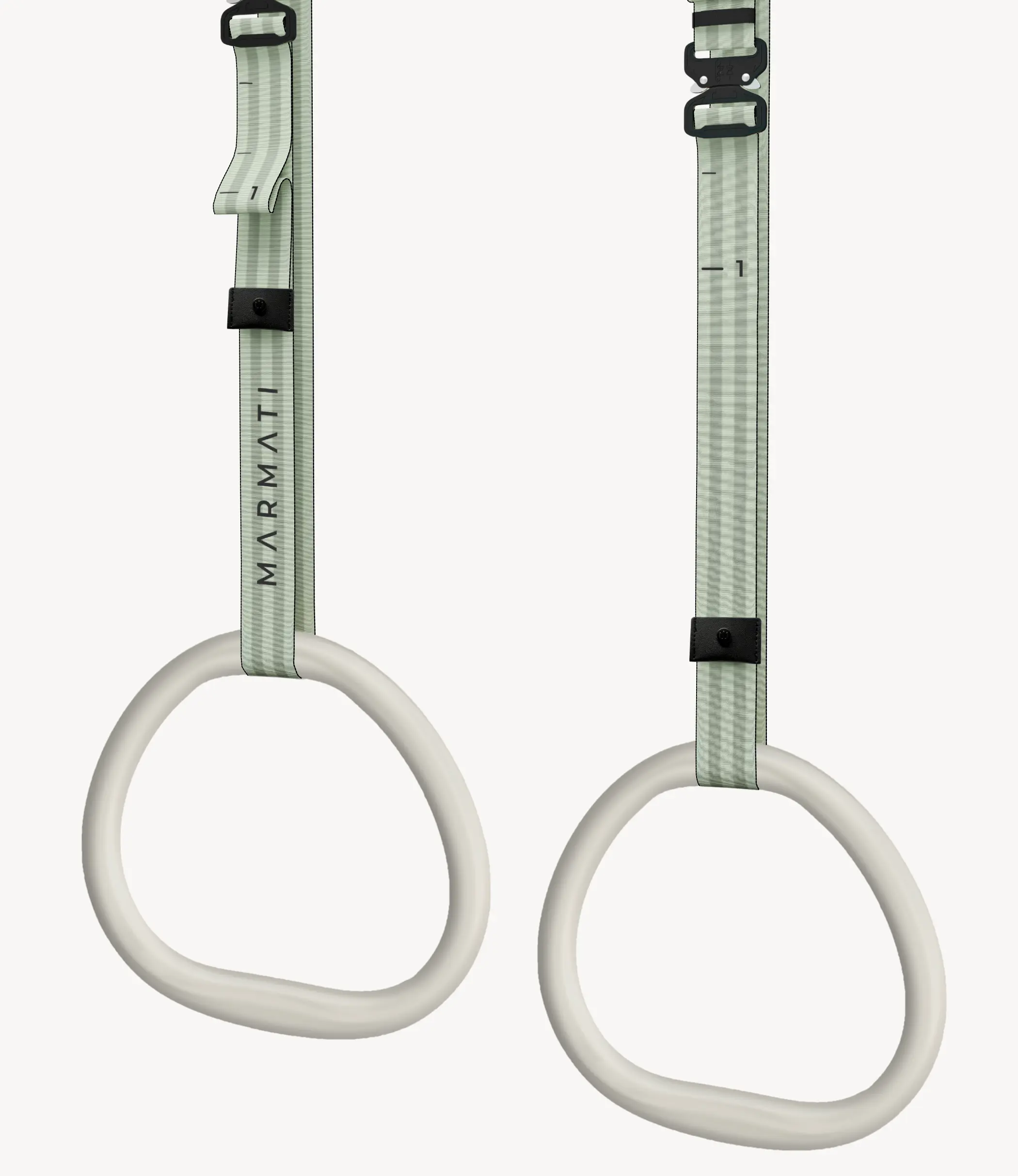 Pair of ergonomic-handle gymnastic rings hanging in a minimalist home gym setting.
