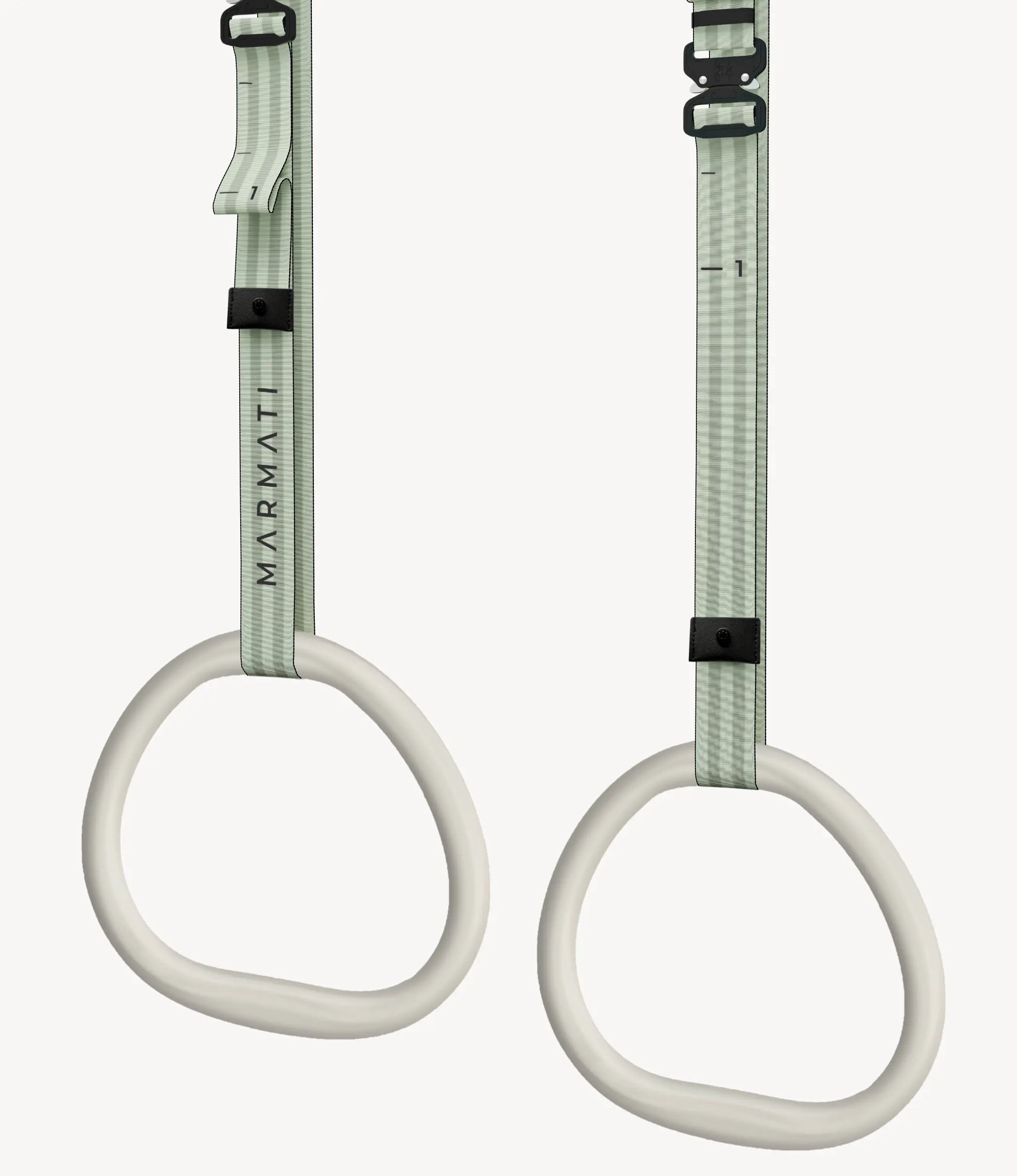 Pair of ergonomic-handle gymnastic rings hanging in a minimalist home gym setting.